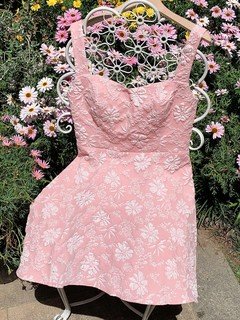 Bow back detail of the pink floral-jacquard bow-back fit-and-flare mini dress, showing floral jacquard, fitted bodice and statement bow back.
