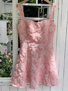 Hanging back view of the pink floral-jacquard bow-back fit-and-flare mini dress, showing the silhouette and fit.