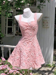 Mannequin front view of the pink floral-jacquard bow-back fit-and-flare mini dress, showing the silhouette and fit.