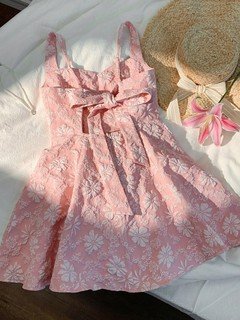 Styled flat lay of the pink floral-jacquard bow-back fit-and-flare mini dress, showing the garment shape and available styling.
