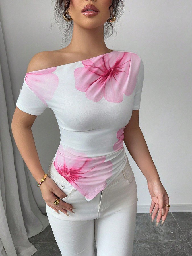 Angled front view of the white and pink floral one-shoulder fitted top, showing its silhouette and design details.