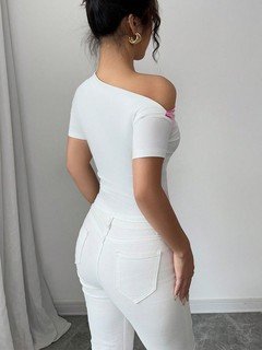 Back view of the white and pink floral one-shoulder fitted top, showing its silhouette and design details.