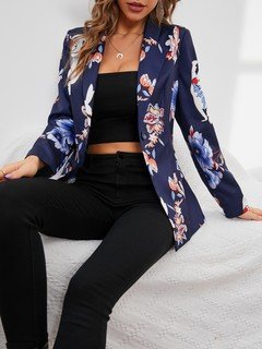 Seated front view of the navy floral-print single-button tailored blazer, showing the silhouette and fit.