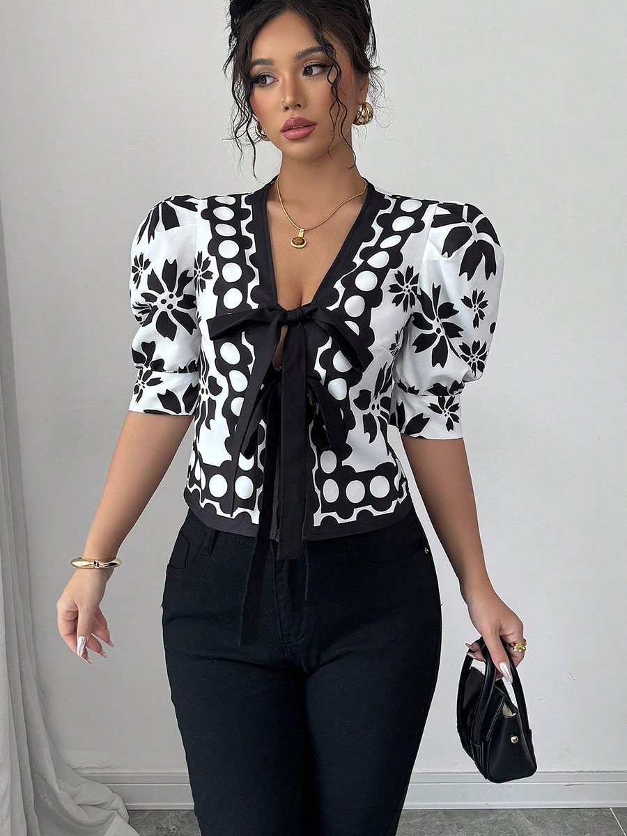 Black And White Floral Puff-Sleeve Tie-Front Top – Front View Front view of the black and white floral puff-sleeve tie-front top, showing its silhouette and design details.