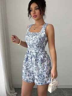 Angled front view of the blue and white floral square-neck tie-back romper, showing its silhouette and design details.