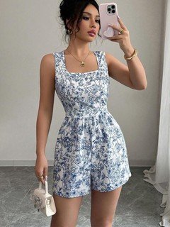 Full-length front view of the blue and white floral square-neck tie-back romper, showing its silhouette and design details.