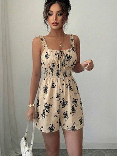 Angled front view of the cream floral smocked ruffle-strap romper, showing its silhouette and design details.