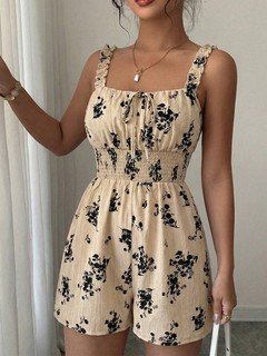 Close-up of the cream floral smocked ruffle-strap romper, showing its silhouette and design details.