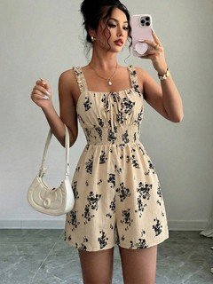 Full-length front view of the cream floral smocked ruffle-strap romper, showing its silhouette and design details.