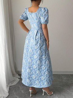 Back view of the blue floral puff-sleeve a-line dress, showing its silhouette and design details.