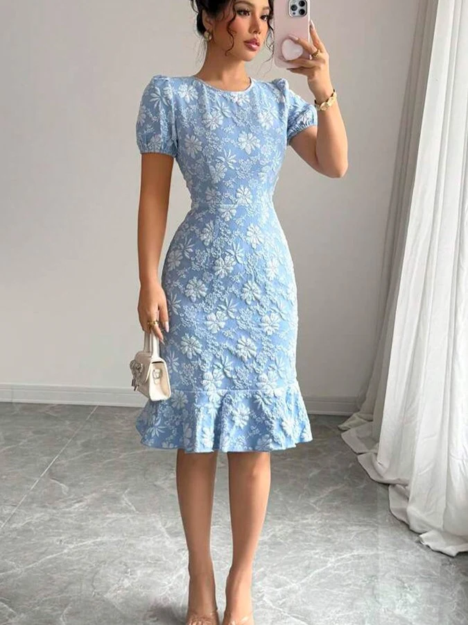 Angled front view of the blue floral textured fishtail dress, showing its silhouette and design details.