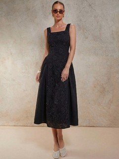 Front view of the black floral textured square-neck dress, showing its silhouette and design details.