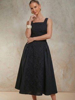 Full-length front view of the black floral textured square-neck dress, showing its silhouette and design details.
