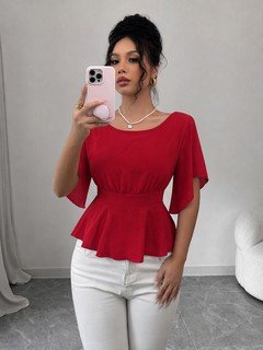 Angled front view of the red flutter-sleeve ruched-waist peplum blouse, showing the silhouette and fit.