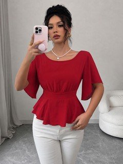 Front close up of the red flutter-sleeve ruched-waist peplum blouse, showing flutter sleeves, ruched waist and peplum hem.