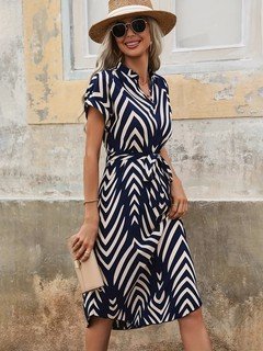 Angled front view of the navy geometric-print v-neck tie-waist midi dress, showing the silhouette and fit.