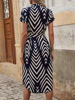 Full length front view of the navy geometric-print v-neck tie-waist midi dress, showing the silhouette and fit.