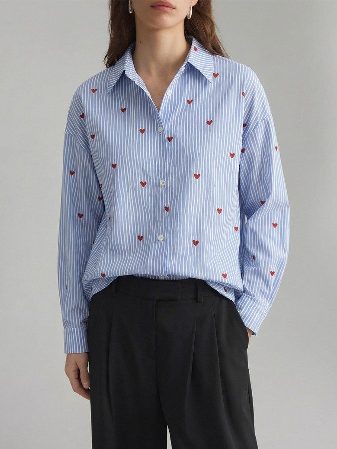 Front view of the blue heart motif striped shirt, showing its silhouette and design details.