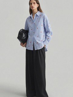 Angled front view of the blue heart motif striped shirt, showing its silhouette and design details.