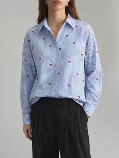 Front view of the blue heart motif striped shirt, showing its silhouette and design details.