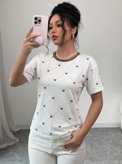 Front view of the white heart-print crew-neck short-sleeve t-shirt, showing the silhouette and fit.