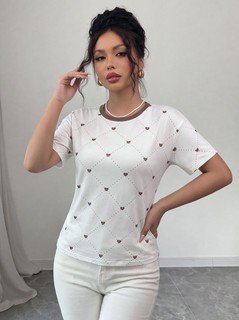 Full length front view of the white heart-print crew-neck short-sleeve t-shirt, showing the silhouette and fit.