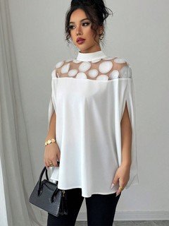 Lifestyle front view of the white circle lace yoke cape blouse, showing its silhouette and design details.