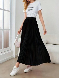 Angled front view of the black accordion-pleated maxi skirt, showing its silhouette and design details.