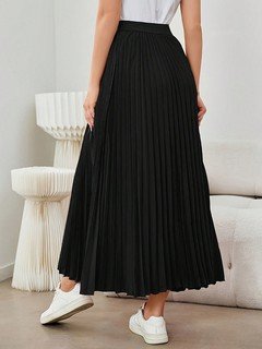 Back view of the black accordion-pleated maxi skirt, showing its silhouette and design details.