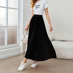 Lifestyle front view of the black accordion-pleated maxi skirt, showing its silhouette and design details.