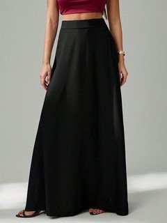 Angled front view of the black pleated a-line maxi skirt, showing its silhouette and design details.