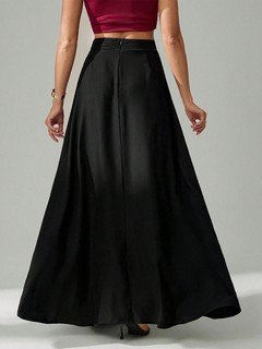 Back view of the black pleated a-line maxi skirt, showing its silhouette and design details.