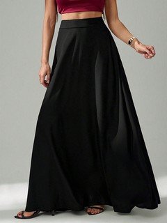 Lifestyle front view of the black pleated a-line maxi skirt, showing its silhouette and design details.