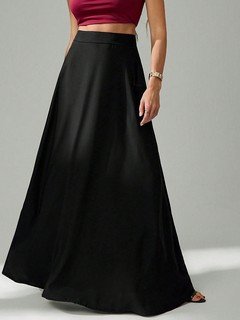 Styled front view of the black pleated a-line maxi skirt, showing its silhouette and design details.