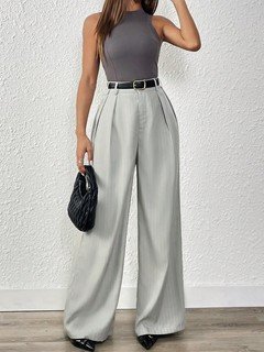 Angled front view of the light gray pleated wide-leg tailored pants, showing its silhouette and design details.