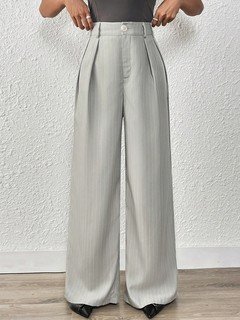 Styled front view of the light gray pleated wide-leg tailored pants, showing its silhouette and design details.