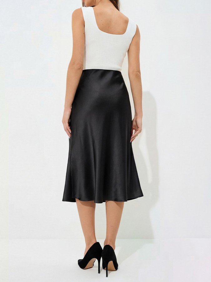 Back view of the black satin a-line midi slip skirt, showing its silhouette and design details.