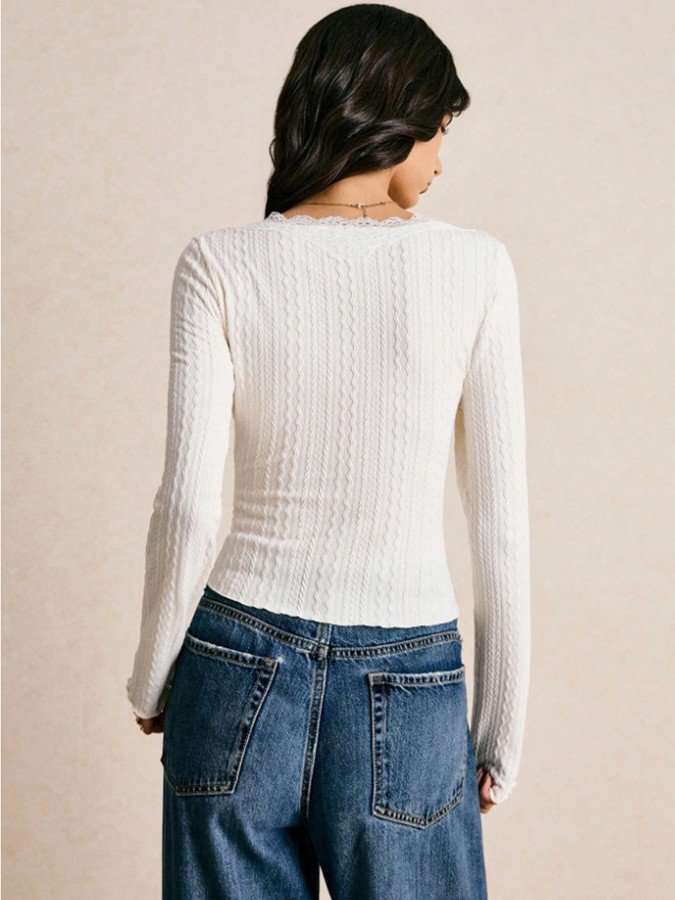 Back view of the ivory lace-trim v-neck ribbed top, showing its silhouette and design details.