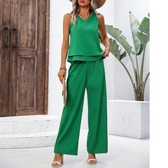 Full length front view of the green layered sleeveless top and wide-leg pants set, showing the silhouette and fit.