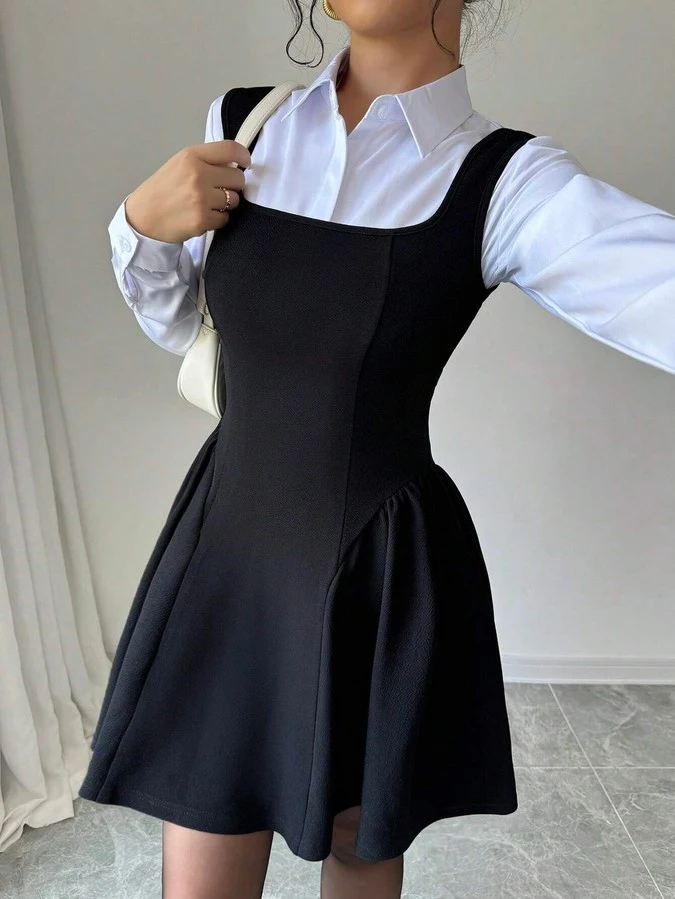 Layered front view of the black layering square-neck sleeveless skater mini dress, showing the silhouette and fit.