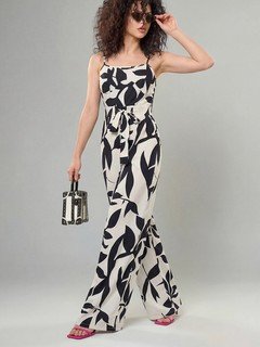 Angled front view of the black and white leaf print wide-leg jumpsuit, showing its silhouette and design details.
