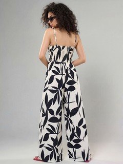 Back view of the black and white leaf print wide-leg jumpsuit, showing its silhouette and design details.
