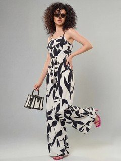 Styled front view of the black and white leaf print wide-leg jumpsuit, showing its silhouette and design details.