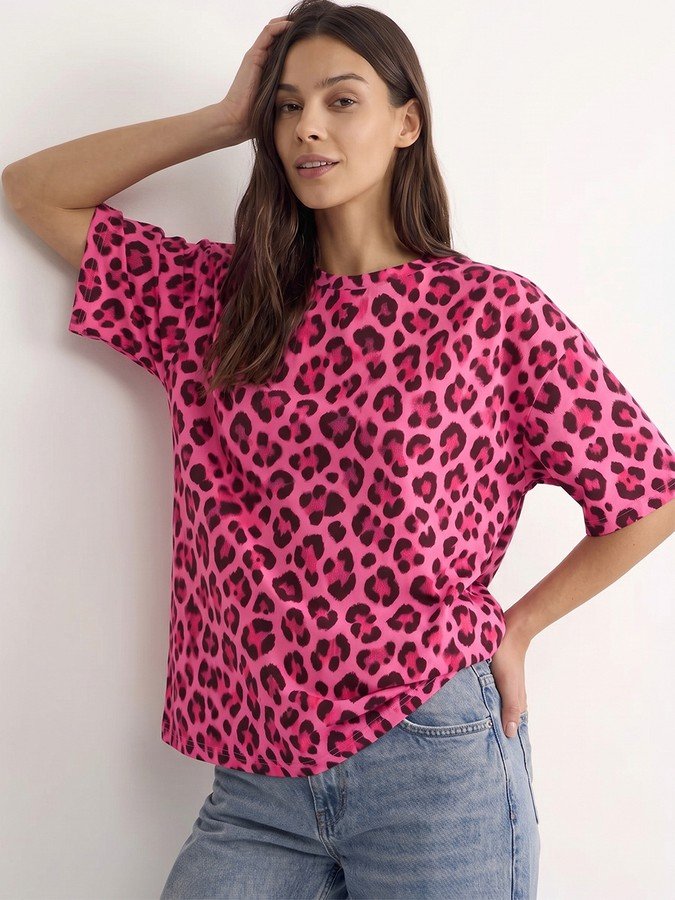 Angled front view of the pink leopard oversized crew-neck tee, showing its silhouette and design details.