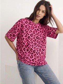 Lifestyle front view of the pink leopard oversized crew-neck tee, showing its silhouette and design details.