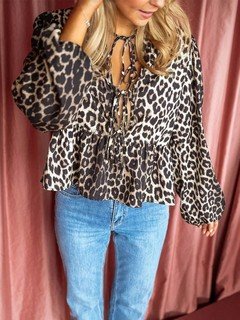 Full-length front view of the brown leopard tie-neck peplum blouse, showing its silhouette and design details.
