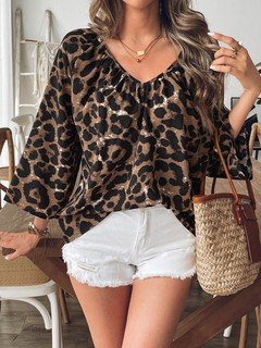 Angled front view of the brown leopard bell-sleeve blouse, showing its silhouette and design details.
