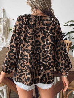 Back view of the brown leopard bell-sleeve blouse, showing its silhouette and design details.