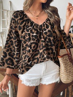 Styled front view of the brown leopard bell-sleeve blouse, showing its silhouette and design details.