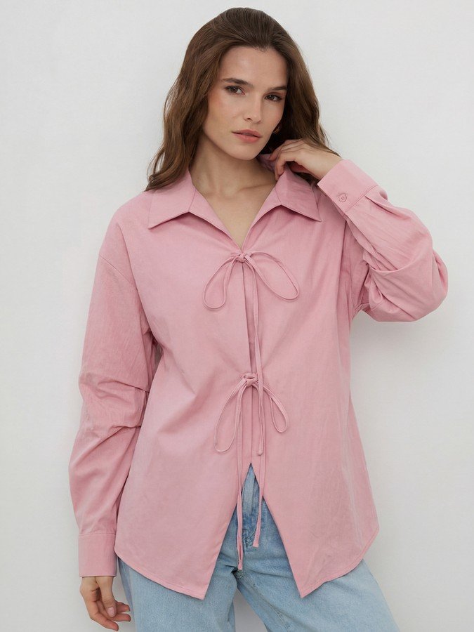 Front view of the pink bow-tie front collared shirt, showing its silhouette and design details.